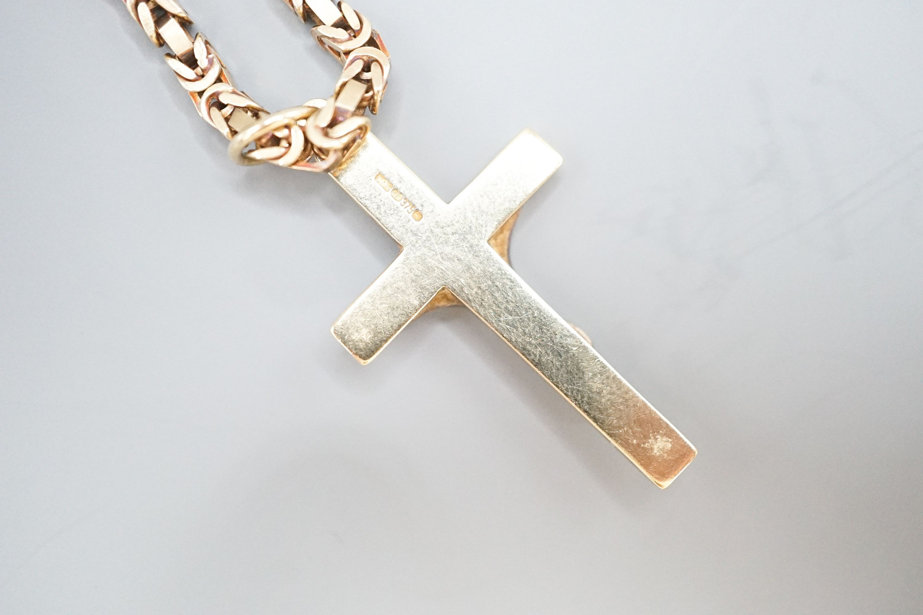 A 9ct gold crucifix pendant, 37mm, on a 9ct gold chain, 47cm